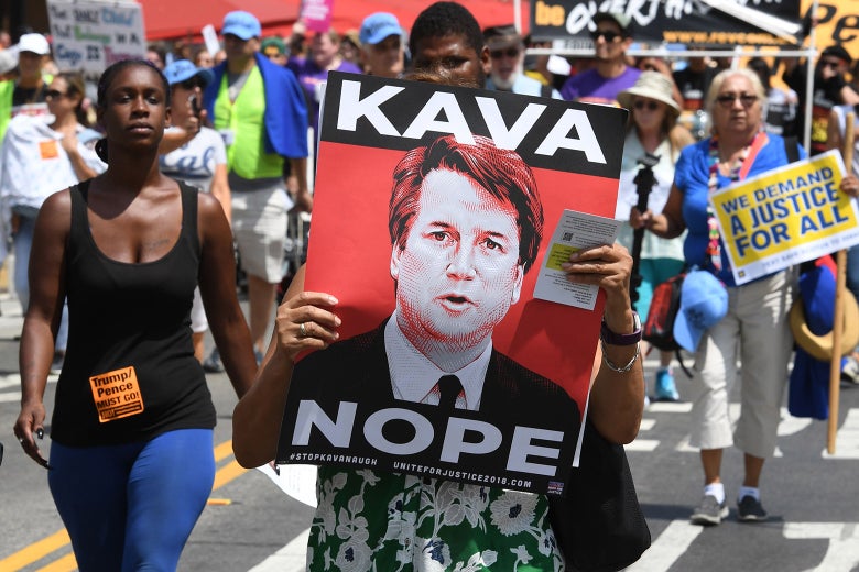 Demonstrators march through the city streets during the Unite For Justice rally in protest of Brett Kavanaugh's confirmation to the US Supreme Court, in Los Angeles, California on Aug. 26, 2018.